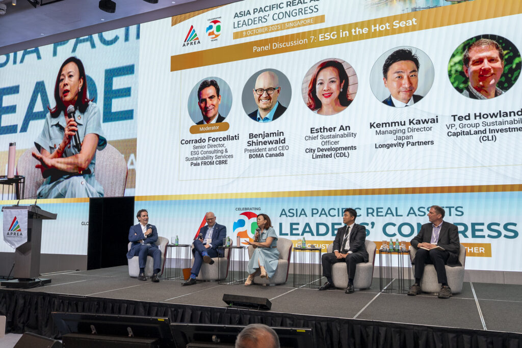 BOMA BEST - Five panelists sit on stage at the Asia Pacific Real Assets Leaders’ Congress, discussing ESG and the resilience dividend, with a large screen displaying their names and roles behind them.