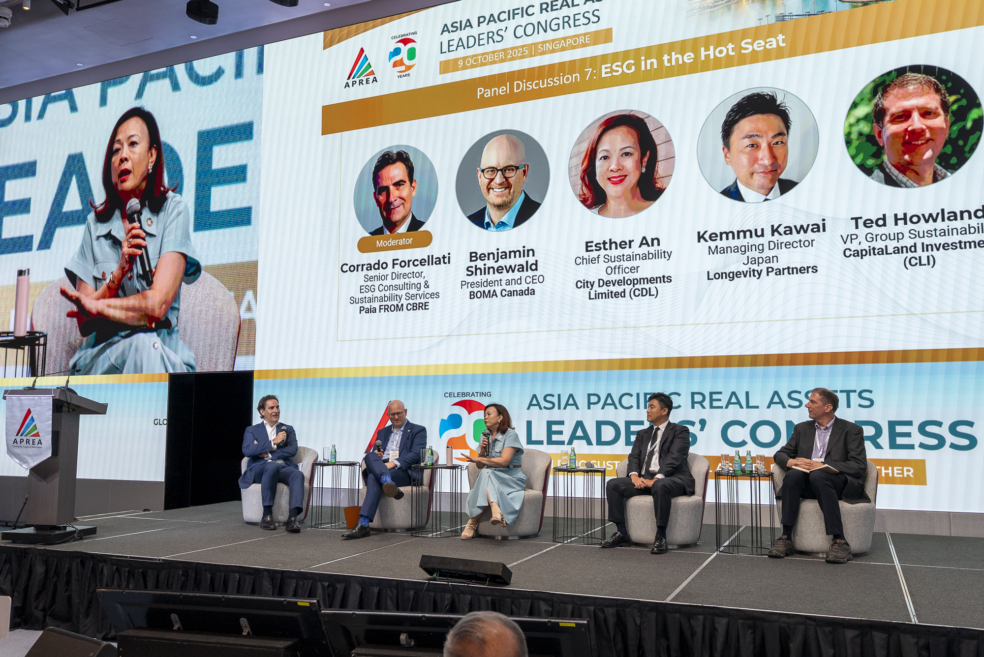 BOMA BEST - Five panelists sit on stage at the Asia Pacific Real Assets Leaders’ Congress, discussing ESG and the resilience dividend, with a large screen displaying their names and roles behind them.